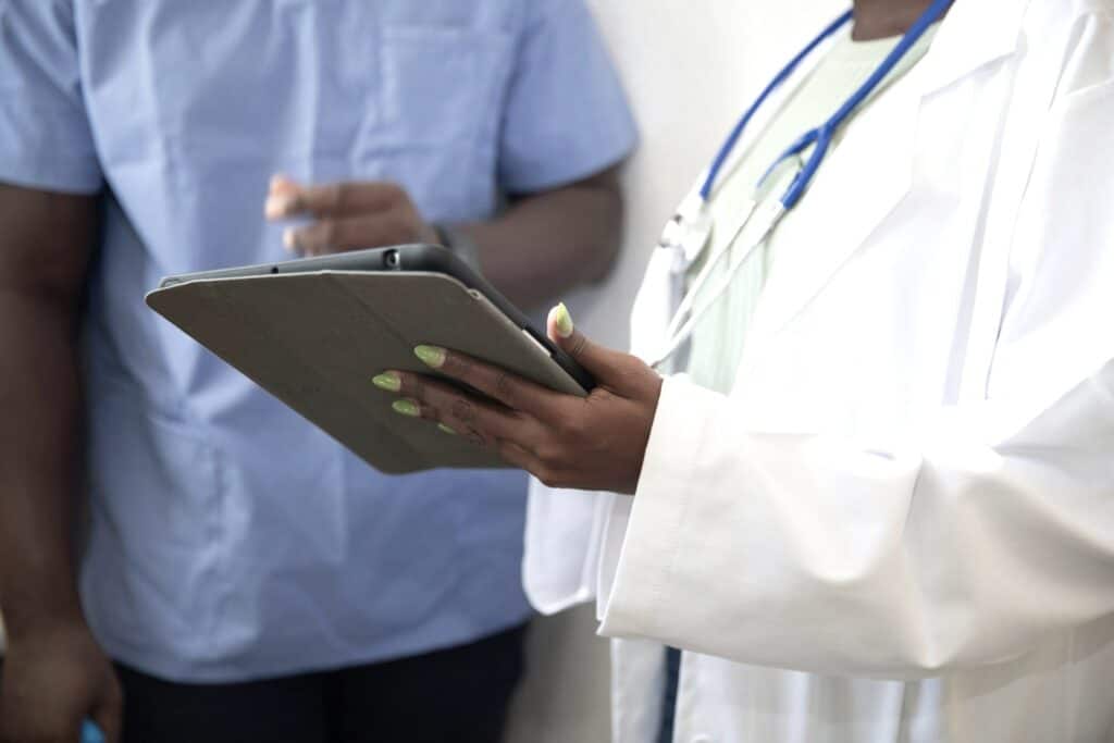 Medical professional prepares patient details before a discreet appointment in a Supportive STI Testing Environment.