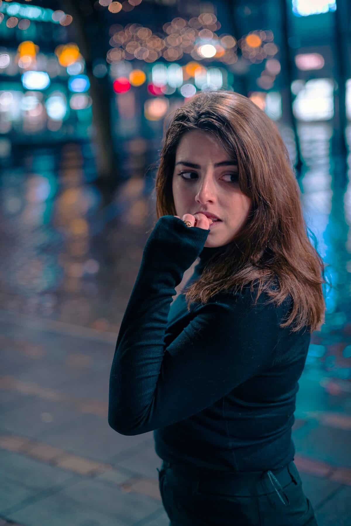 A fearful woman appears anxious in public, overwhelmed by past emotions from Encoded Traumatic Memories in the brain.