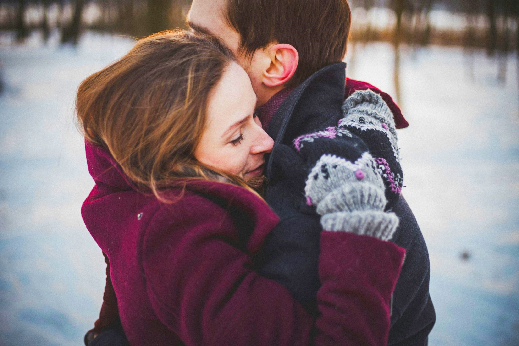 Couple sharing a warm hug outdoors, showing emotional connection and Evolving Relationships before Valentine’s Day.
