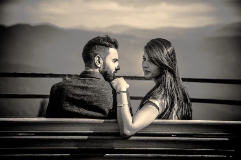 Couple seated apart in silence symbolising growing distance and early signs of Neglect In Romantic Relationships.