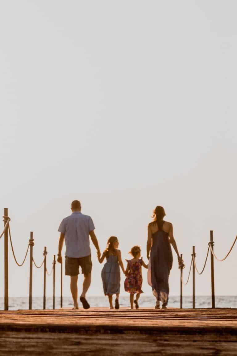 Family walking hand in hand at sunset, symbolising connection and New Year Bonding Ideas.