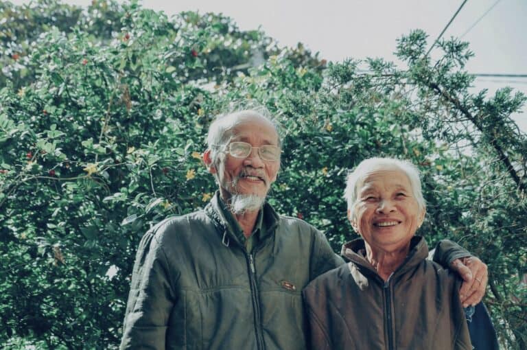 Smiling elderly couple symbolising Ageing Relationship Challenges relationship dynamics changing over time throughout the elderly years with changing roles.