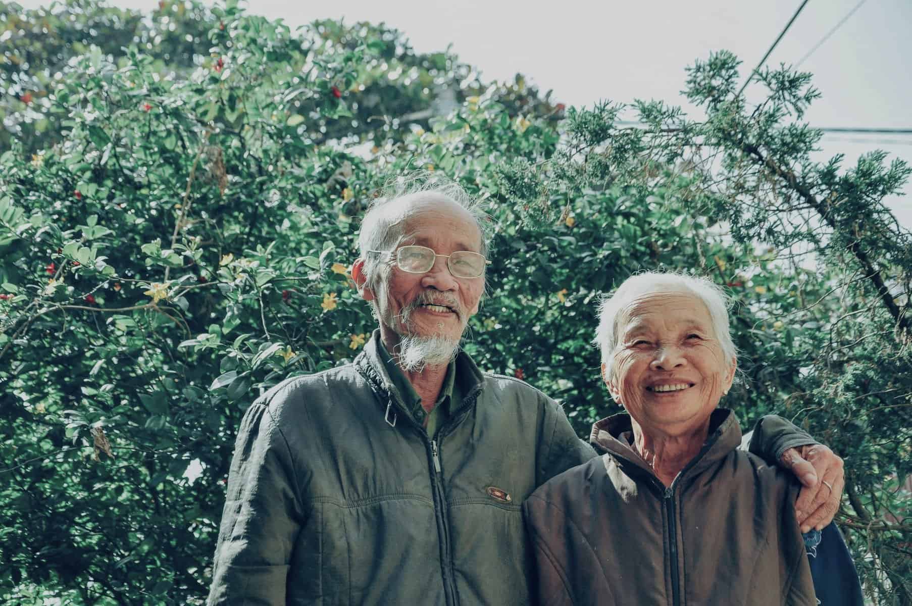 Smiling elderly couple symbolising Ageing Relationship Challenges relationship dynamics changing over time throughout the elderly years with changing roles.
