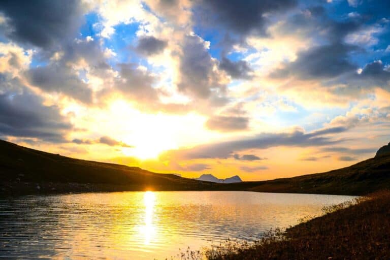 Quiet sunrise over still water, symbolizing reflection, simplicity, and inner clarity Beyond External Validation.