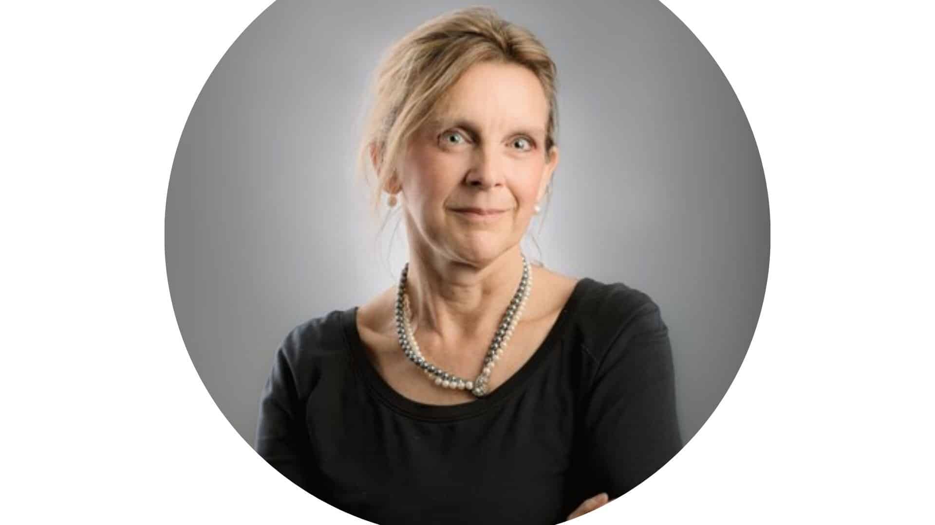 A portrait of Gwen Ashead, a professional in mental health and psychology, looking confident and approachable.