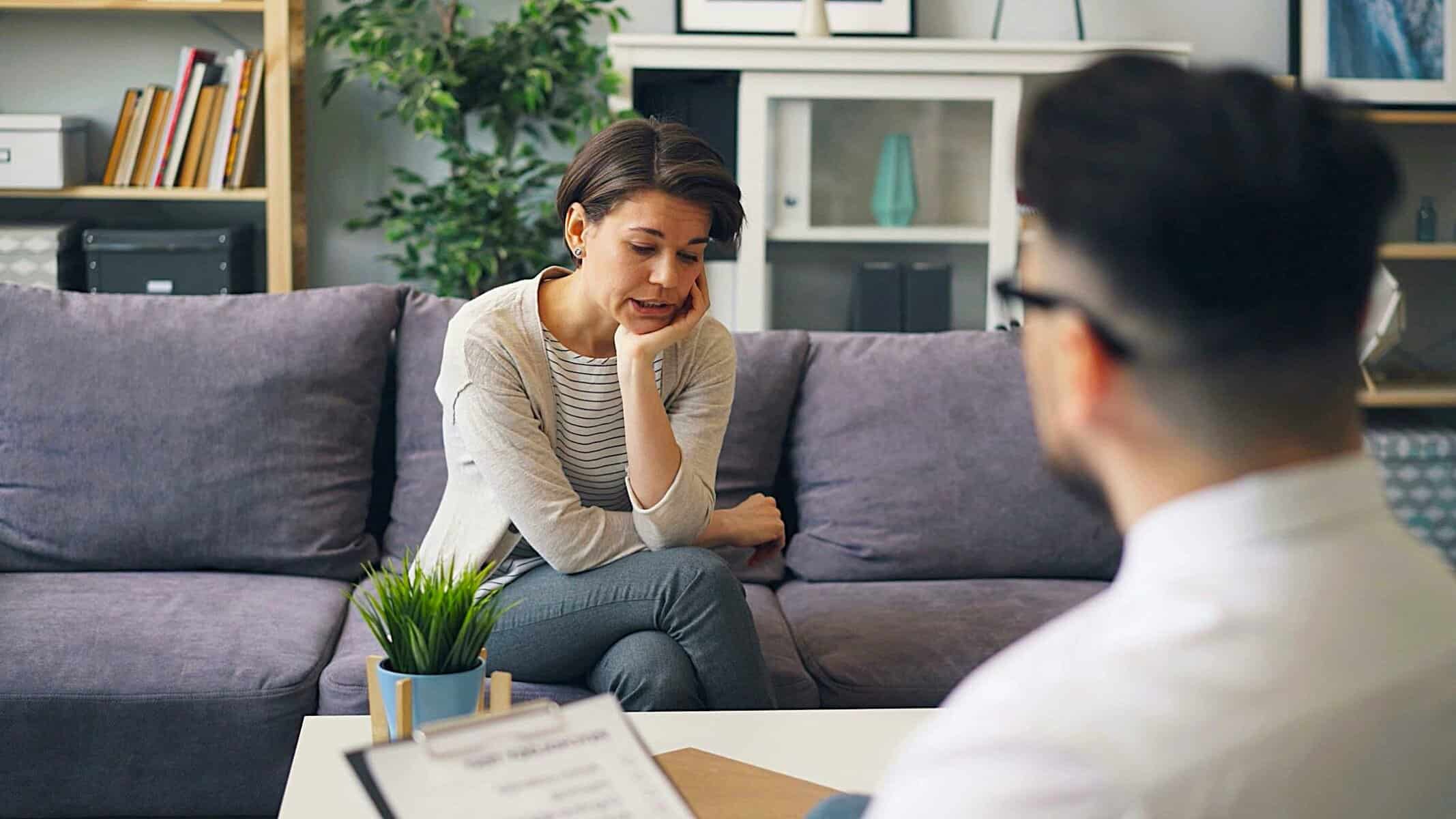 Woman in therapy, reflecting on trauma not only belonging to one person but passed down without words, thanks to Generational Trauma Transmission.
