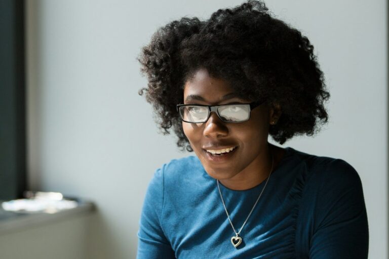 Smiling woman in conversation at a table